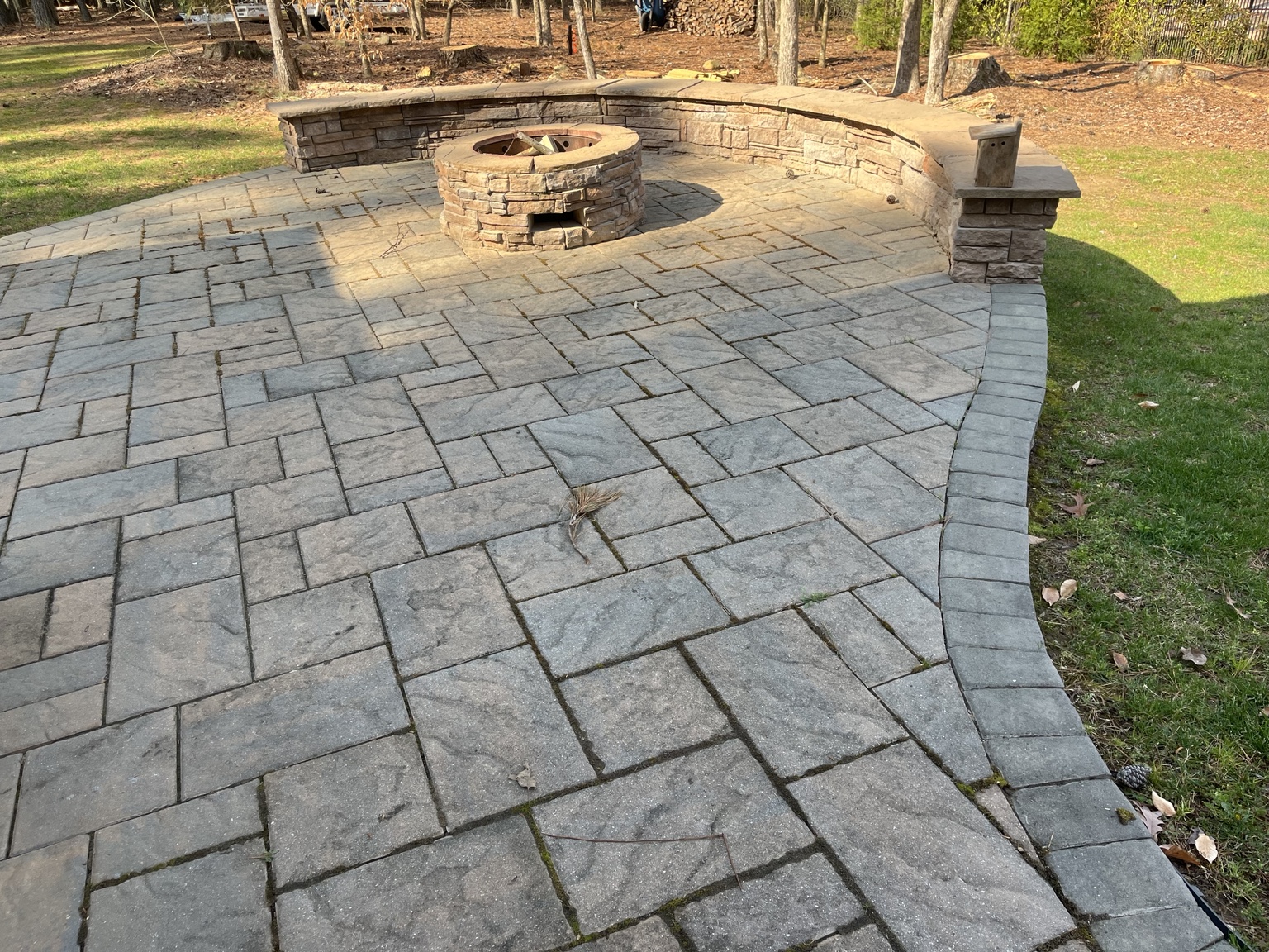 Paver patio with fire pit and seating wall